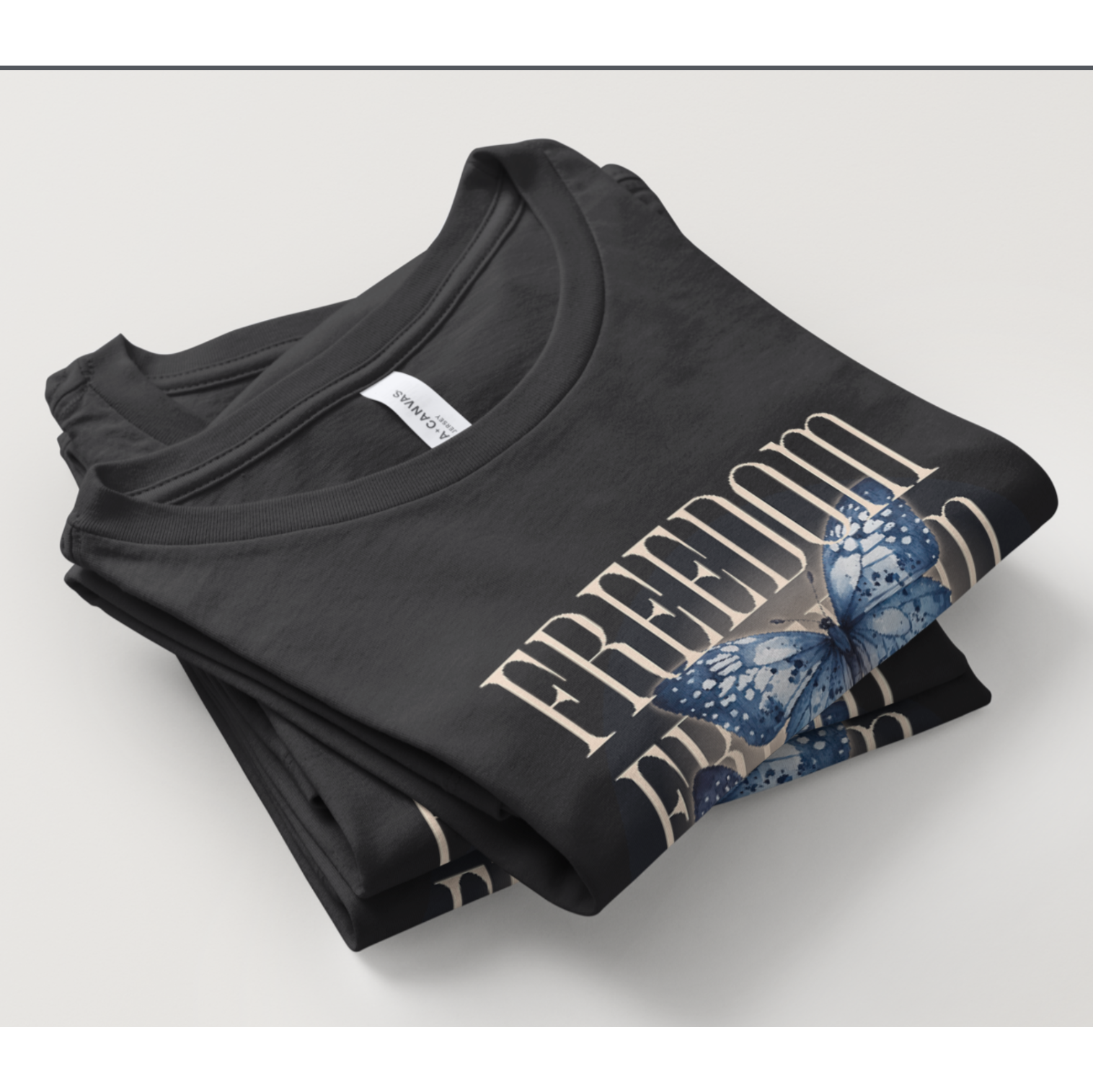 Folded black t-shirt with butterflies design on a light gray background